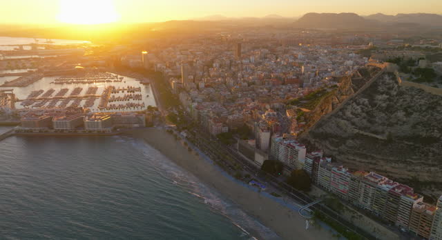 Sunset over the city center and marina of Alicante city, medieval fortess of Santa Barbara. Spain, Costa blanca