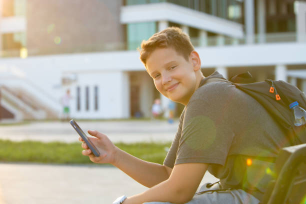 istock Teenage school boy learning using mobile phone 1958394259