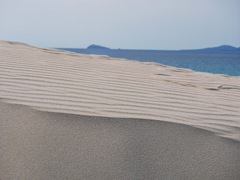 Sand dunes at the background of the sea in Porto Pino, Sardinia