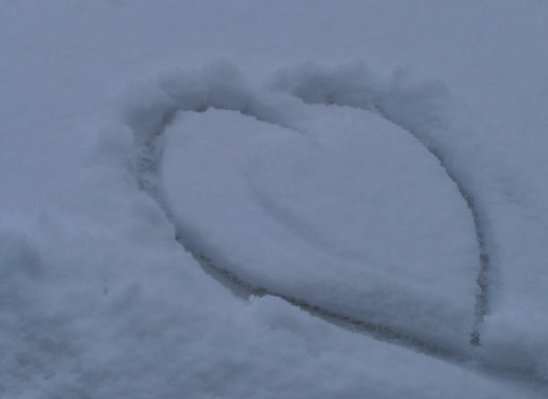 istock Heart drawn in Snow on Car Window 1958427661