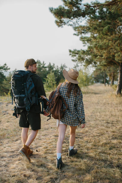 istock Young couple hiking on mountain. Back view. 1958453871