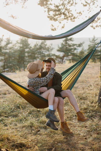 istock A couple in love are hugging while lying in a hammock in nature. 1958454416