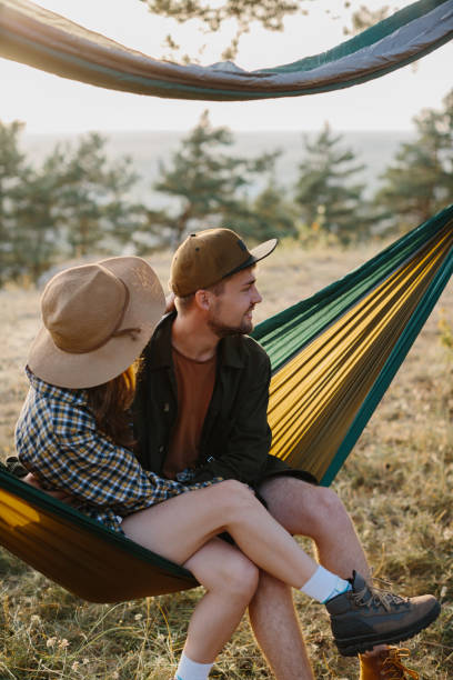 istock A couple in love are hugging while lying in a hammock in nature. 1958454421