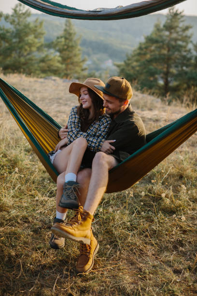 istock A couple in love are hugging while lying in a hammock in nature. 1958454423