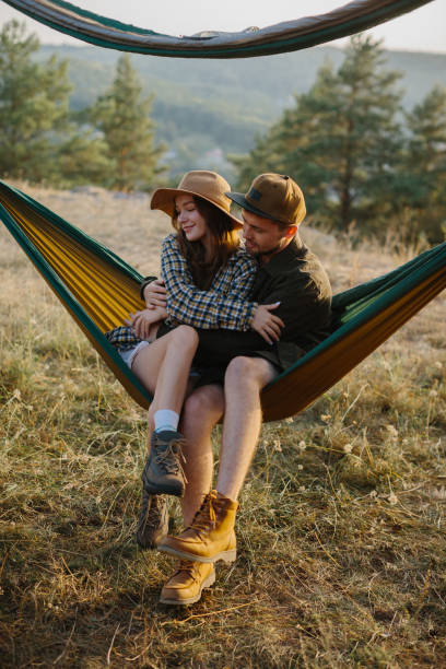 istock A couple in love are hugging while lying in a hammock in nature. 1958454424