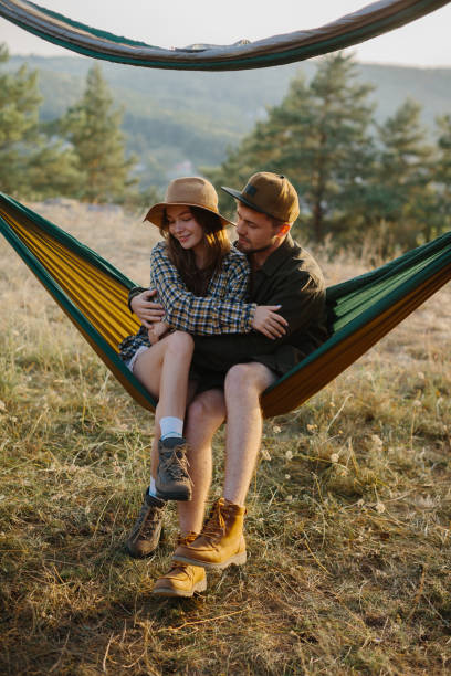 istock A couple in love are hugging while lying in a hammock in nature. 1958454425