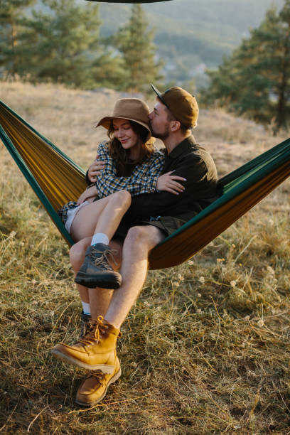 istock A couple in love are hugging while lying in a hammock in nature. 1958454438