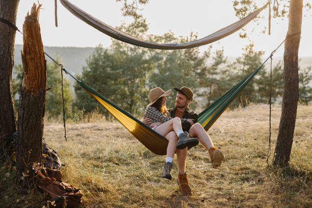 istock Happy couple in love enjoying the sunset outdoors while relaxing in a hammock. 1958454443