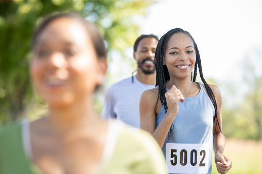 Adults from different walks of life come together for a 5k charity run, benefiting a good cause.