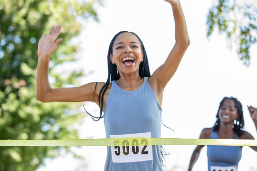 A diverse array of adults collectively engages in a 5k charity race, benefiting a good cause.