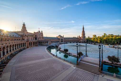Sun rising early in the mornig in an empty Spanish Square in Seville. Spain