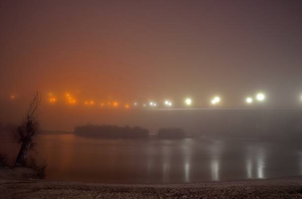 Bank of the Duero River with fog, in Tordesillas with its medieval bridge