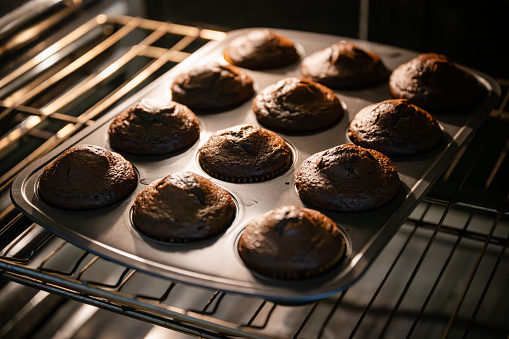 freshly baked chocolate cupcake in oven
