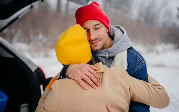 Young couple getting ready to go camping on a snowy day