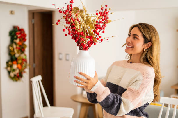 Latin woman aged between 25-35 years old is decorating her house for Christmas