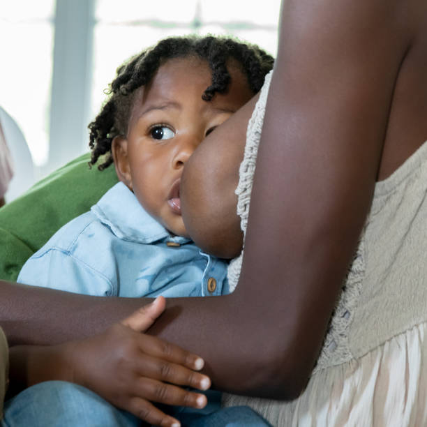 istock One year old little boy is breastfeeding at home in nursery 1958566574