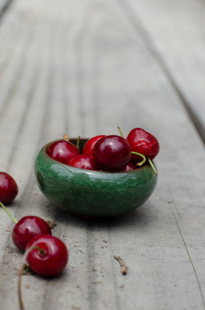 istock two fresh cherries on wooden table outdoors, close up 1958572721