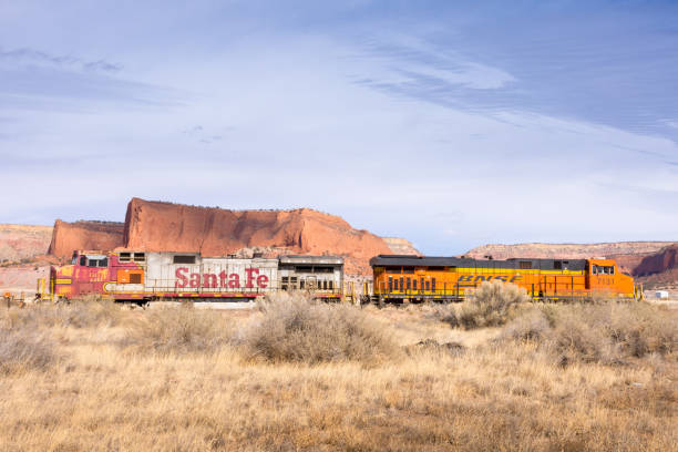 Church Rock, New Mexico - USA: Silver Santa Fe Railroad engine back to back with an orange BNSF engine along Route 66 with classic American southwest background