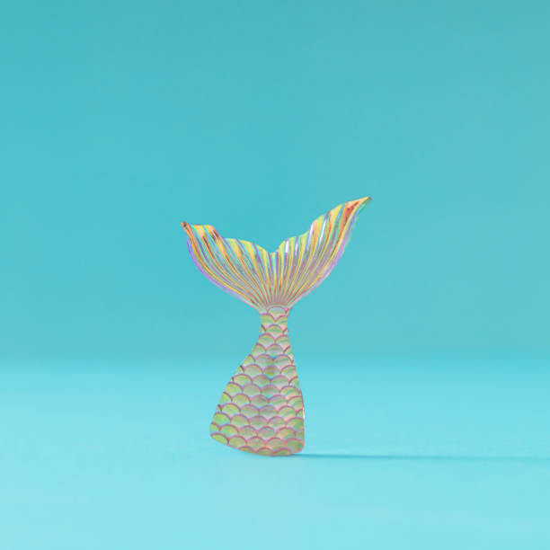 istock Summer layout made with mermaid's tail on light bright blue background. Minimal summer concept. Creative idea of pinkish orange mermaid diving into the sea. Summer aesthetic. 1958622072