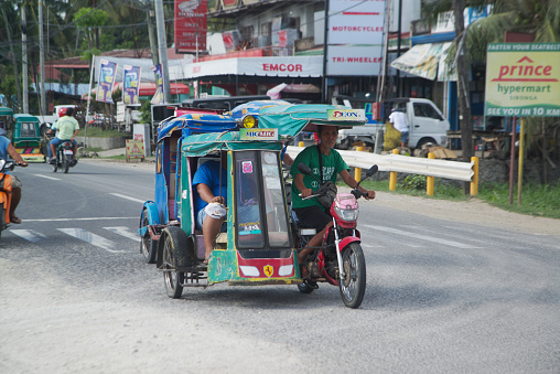 Cebu , Pilippines - January 27,2020 : Three-wheeled vehicles on the road, called Tatlong-wiler motorized tricycles. How to transport passengers everywhere in the Philippines on January 27,2020.
