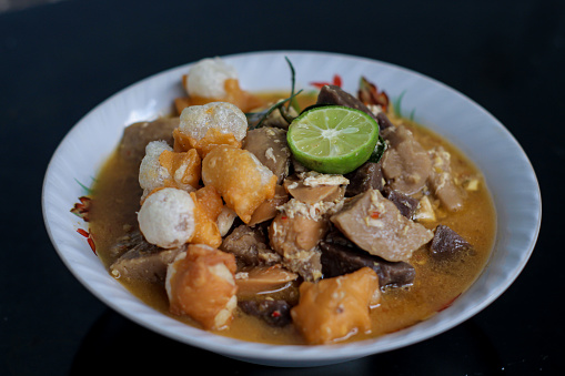 Traditional Indonesian food spicy and savory Seblak Jeletot, with toppings of wet crackers, meatballs, chicken, etc. Cooked with spicy sauce, from Sunda, West Java.