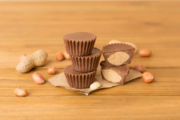 istock Tasty chocolate peanut butter cups on wooden table 1958758875