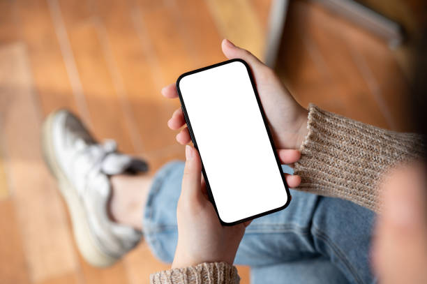 istock A woman using her smartphone while sitting indoors, chatting or reading an online blog. 1958828323