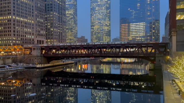 Night time Chicago city view video of elevated ('el) train crossing the Franklin Street bridge