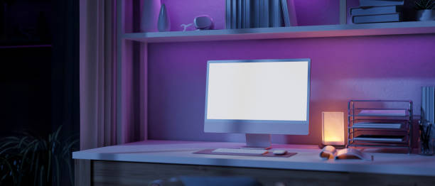 istock A modern home office workspace with a computer and a dim light from a table lamp on a table. 1958918854