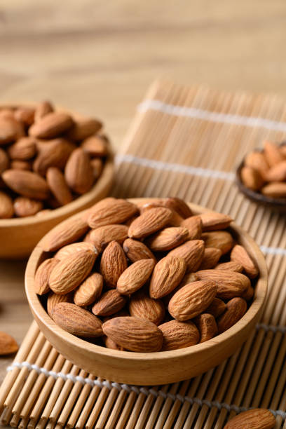 istock Raw almond nut in bowl on wooden background 1958963447