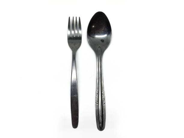 istock stainless steel spoon and fork on isolated background 1958996848
