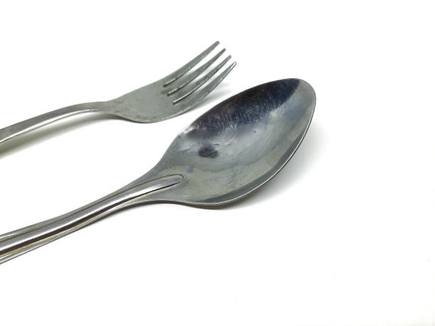 istock stainless steel spoon and fork on isolated background 1958997363