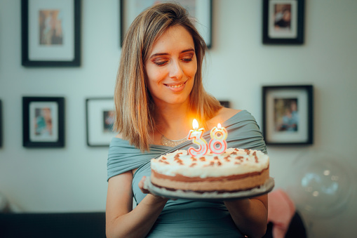 Cheerful lady throwing herself an anniversary party