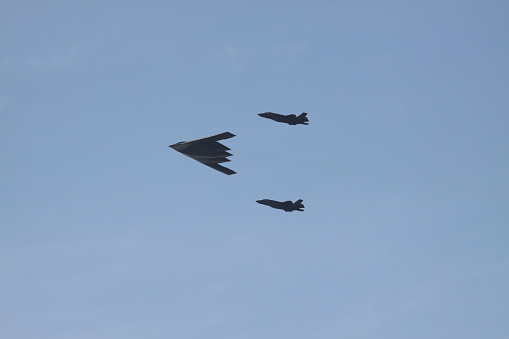 View of loud B-2 Spirit stealth bomber with its two F-35 Lightning fighter jet escort during flyover of San Gabriel Valley on New Year's Day morning 2018.