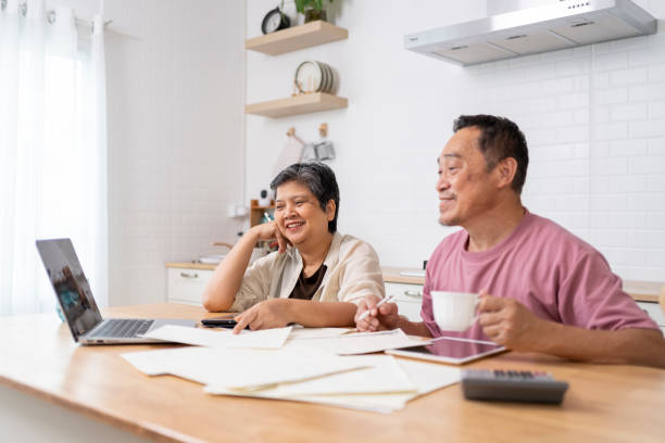 istock Happy Asian senior couple use digital technology device to working at home 1959059749