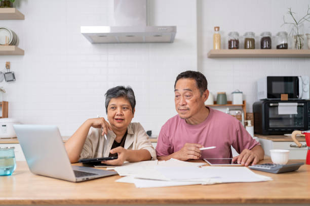 istock Happy Asian senior couple use digital technology device to working at home 1959059757