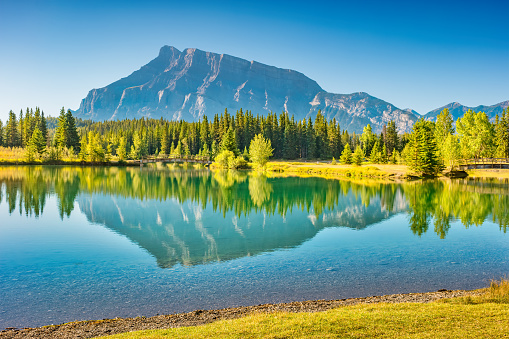 Tranquil landscape with Mt Rundle reflecting in Two Jack Lake, Banff National Park, Alberta Canada.