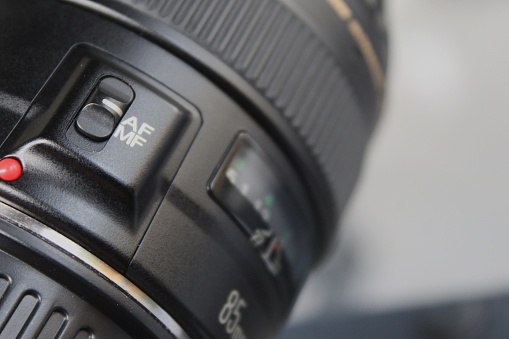 A photo of a modern digital single lens reflex camera on a white background.