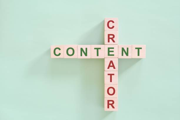istock Content creator concept. Wooden blocks flat lay typography composition in green background. 1959090428