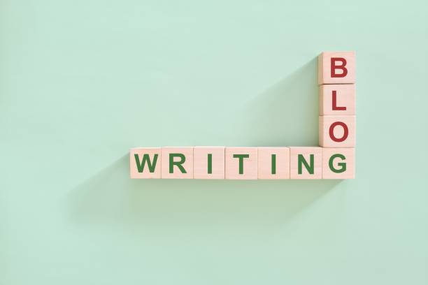 istock Blog writing concept.  Wooden blocks flat lay typography composition in green background. 1959090931