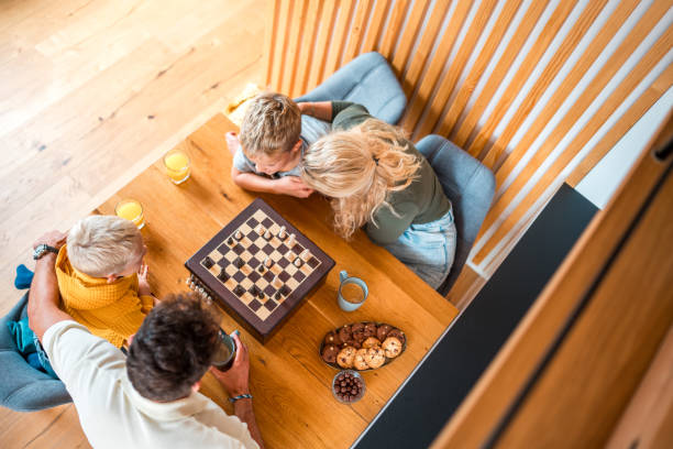 istock Brothers and Parents Engaging in a Chess Game 1959111865