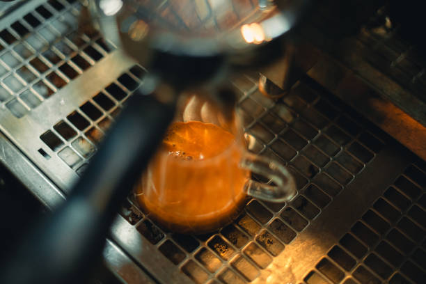 istock Coffee from the machine in the cafe,Coffee flows into the glass 1959148375