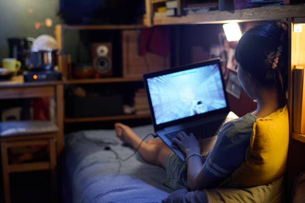 istock Girl playing computer game at home 1959151957