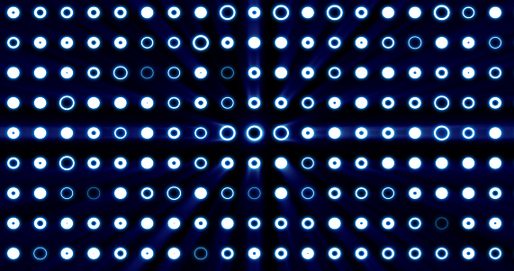 Abstract background of bright blue glowing light bulbs from circles and dots of energy magic disco wall.