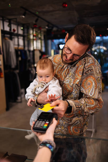 istock Father and his baby paying for stuff they bought 1959167119