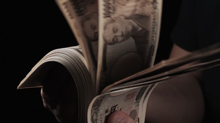 Man's Hand Holding Stack of Bills