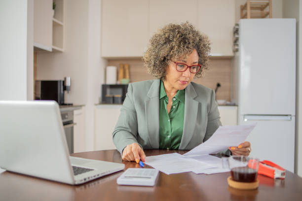 istock Mature woman going through paperwork 1959175077