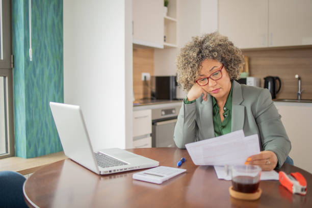 istock Mature woman going through paperwork 1959175078
