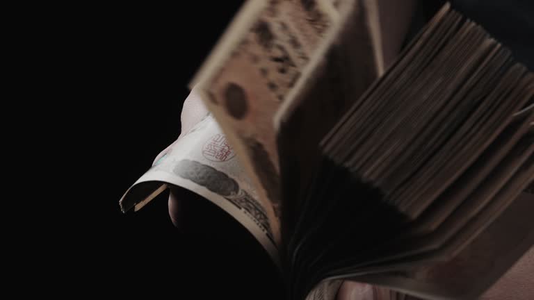 Man's Hand Holding Stack of Bills