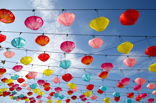 Focus scene on Chinese New Year decorations - pastel coloured lanterns in temple